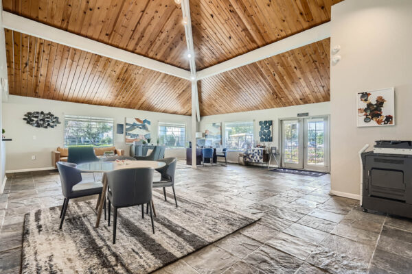Sunset Peak apartments indoor community spaces with gray tiled floors, lounge space, and a printer