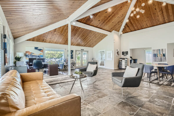 Sunset Peak apartments indoor community spaces with gray tiled floors, lounge space, and a full kitchen