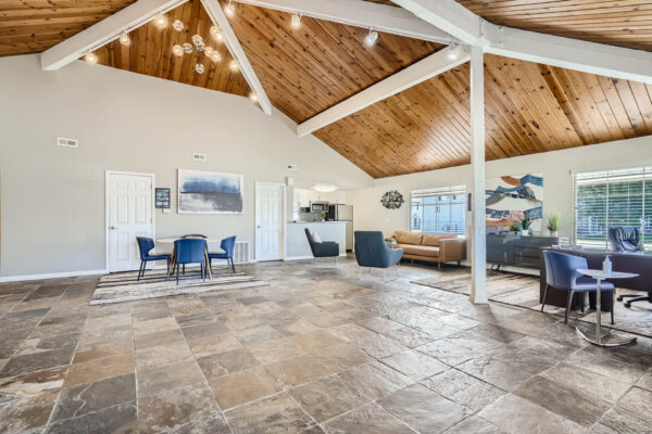 Sunset Peak apartments indoor community spaces with gray tiled floors, lounge space, and a full kitchen