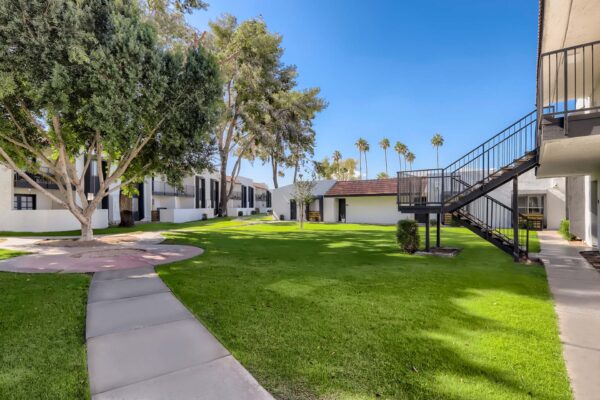 Tempe Vista apartments courtyard with paved walkways and lush landscaping.