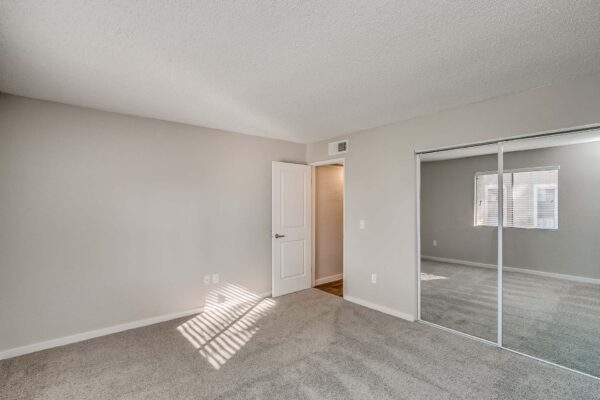 Tempe Vista apartment bedroom with plush carpet and large closet.