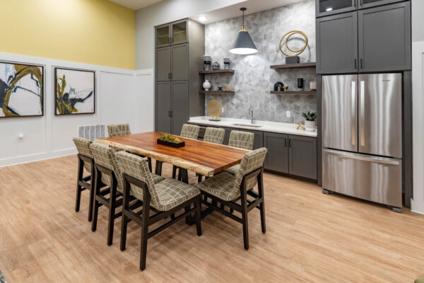 The Avery apartments community kitchen with large dining table.