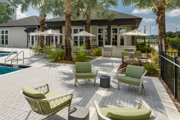 The Avery apartments pool area with lounge chairs and BBQ grill.