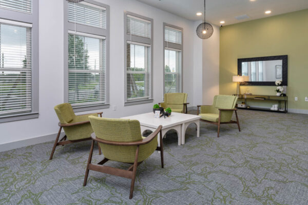 The Avery apartments lounge with plush seating and large windows.