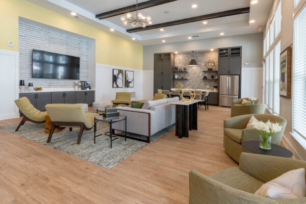 The Avery apartments lounge with plush seating, TV, and community kitchen.