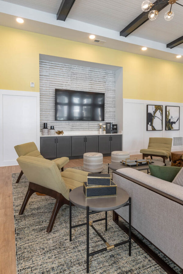 The Avery apartments lounge with plush seating and TV.