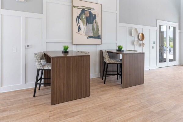 The Avery apartments lobby with tables and stools.