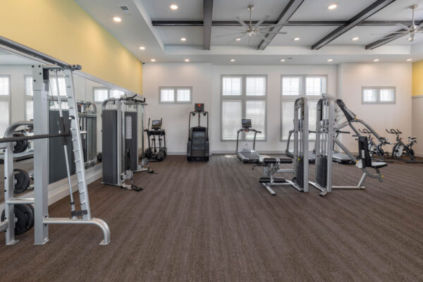The Avery apartments fitness center with cardio machines and weight equipment.