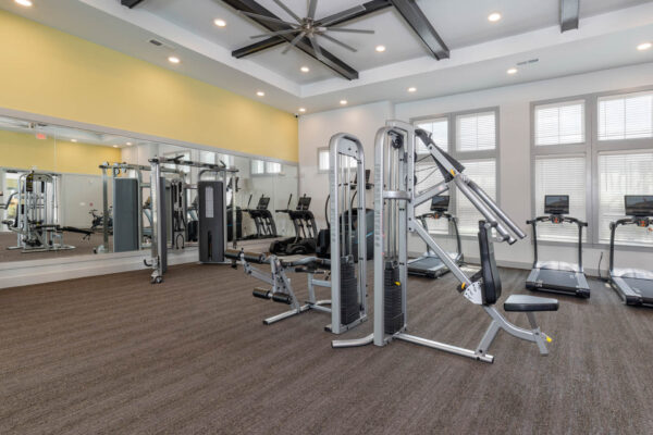 The Avery apartments fitness center with cardio machines and weight equipment.
