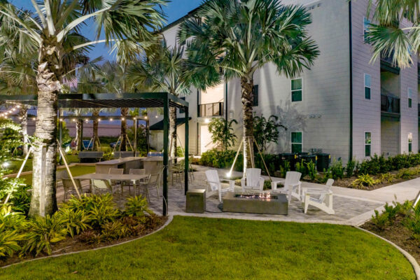 The Avery apartments outdoor lounge with chairs, fire pit, and pergolas.