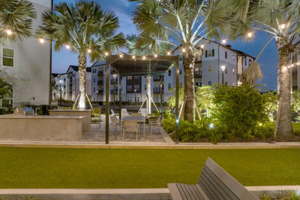 The Avery apartments outdoor lounge with pergolas, lounge chairs, and BBQ grill.