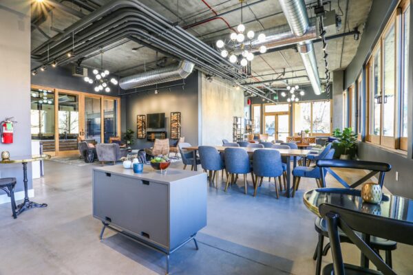 The Economist apartments lounge with dining tables and plush seating.