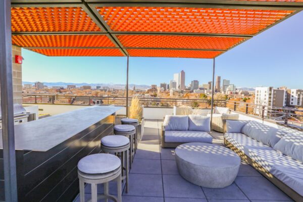 The Economist apartments rooftop deck with outdoor furniture, BBQ grill, and gazebo.