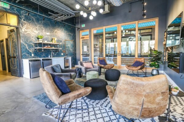 The Economist apartments lounge withp lush seating and industrial design.