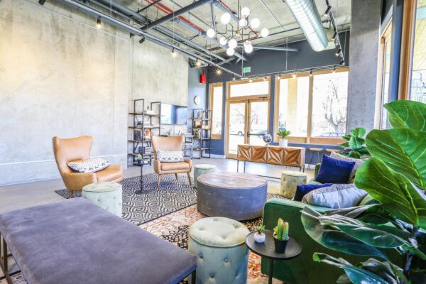 The Economist apartments lounge with plush seating, large windows, and industrial design.