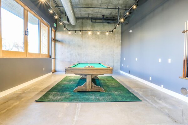 The Economist apartments game room with pool table.