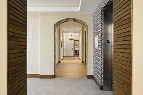 The Locale apartments hallway with wood and tile textured walls.