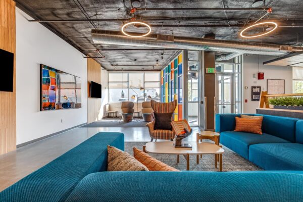 The Overland apartment lounge with plush seating and industrial styling.