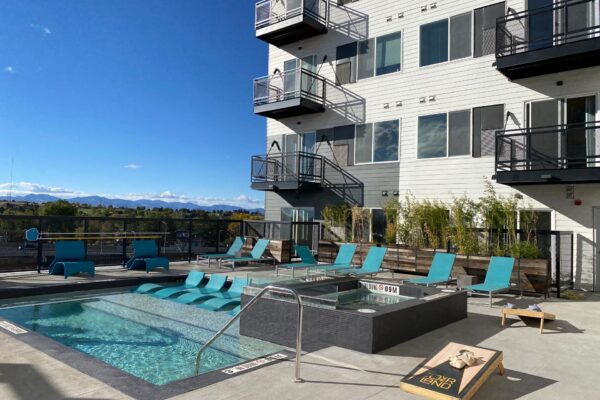 The Overland apartments rooftop deck with pool, hot tub, and lounge chairs.