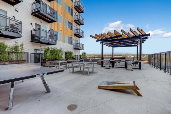 The Overland apartments rooftop deck with bag toss, table tennis, and BBQ grills.