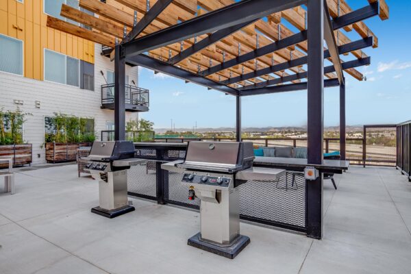 The Overland apartments rooftop deck with pergola and BBQ grills.