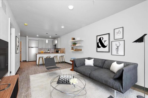 The Overland apartment living area with plush seating, shelves with decor, and wall art.