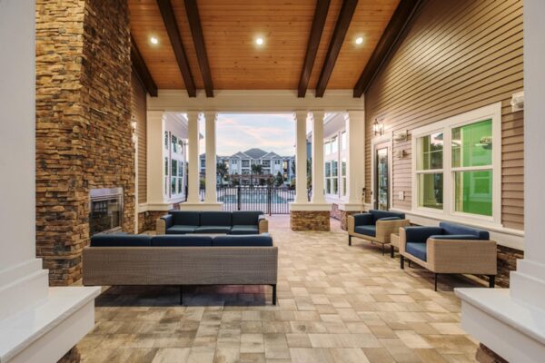 The Point at Bella Grove apartments outdoor lounge with fireplace and lounge chairs.