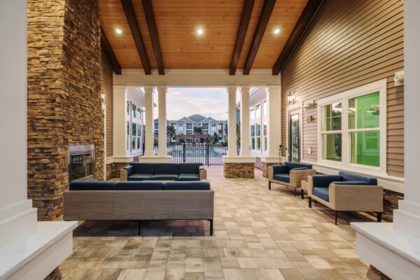 The Point at Bella Grove apartments outdoor lounge with fireplace and lounge chairs.