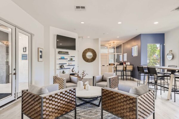 Villas at Mountain Vista Ranch apartments clubroom with plush seating, TV, and eclectic decor.
