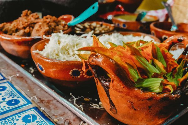 Cooking trays filled with Mexican food.