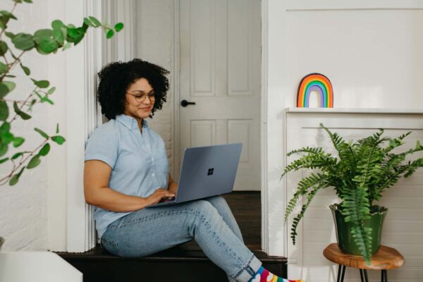 women sitting on her computer