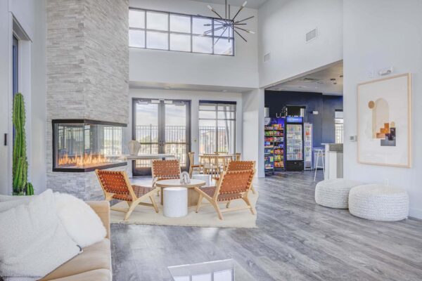 Copper 87 apartments clubhouse with wood furniture, fireplace, and vending machines.