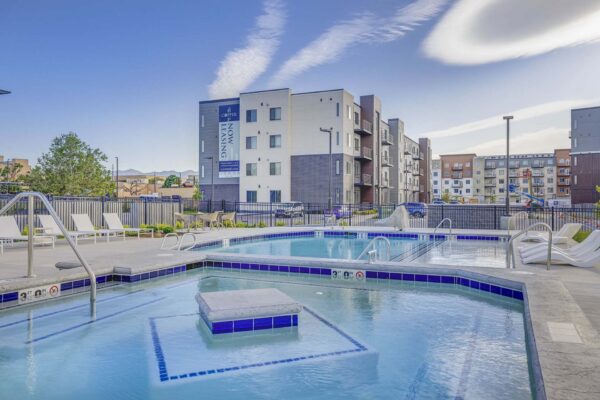 Copper 87 apartments pool area with hot tub and lounge chairs.