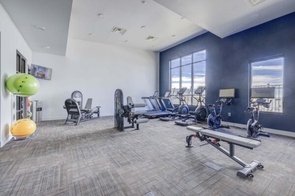 Copper 87 apartments fitness center with cardio machines and weight equipment.