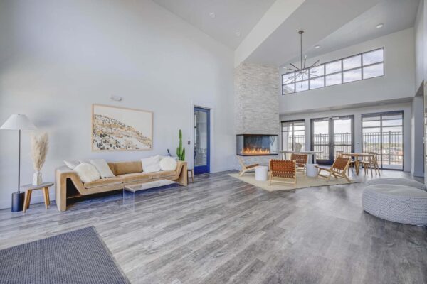 Copper 87 apartments clubhouse with modern couch, wood furniture, and fireplace.