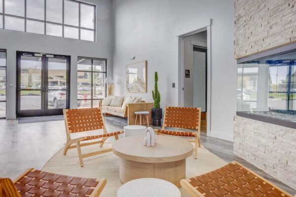 Copper 87 apartments clubhouse with wood furniture, fireplace, and large windows.