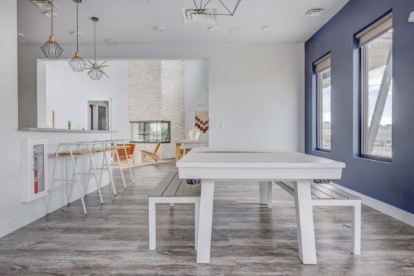 Copper 87 apartments community kitchen with large dining table.