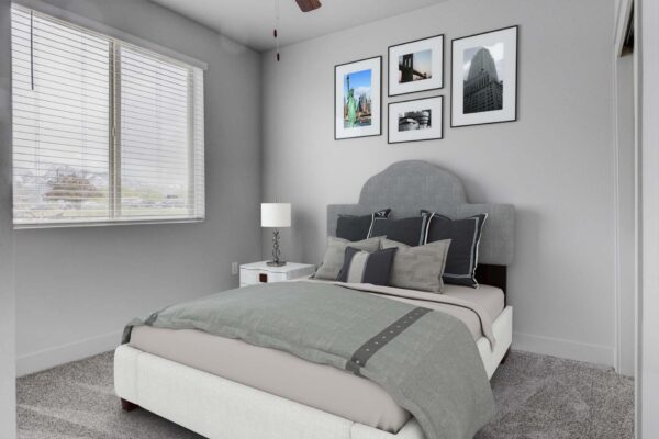 Copper 87 apartments bedroom with carpet, plush bed with headboard, and large windows.