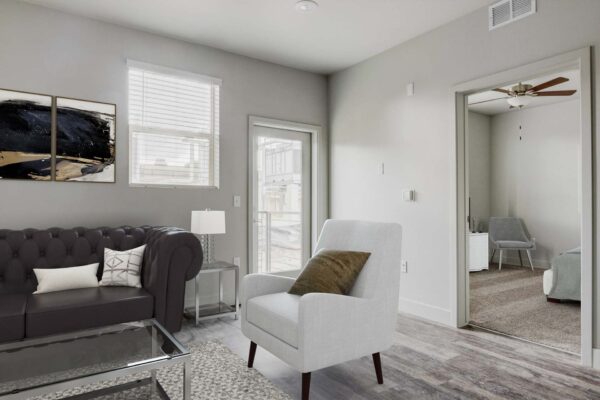 Copper 87 apartments living room with plush seating and large window.