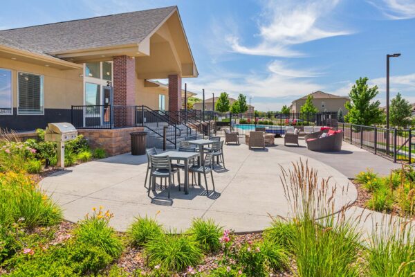 Polaris Peak outdoor lounge with dining tables and BBQ grill.