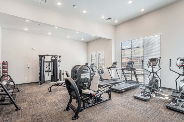 The Marc at Monument Ridge fitness center with cardio machines and weight equipment.