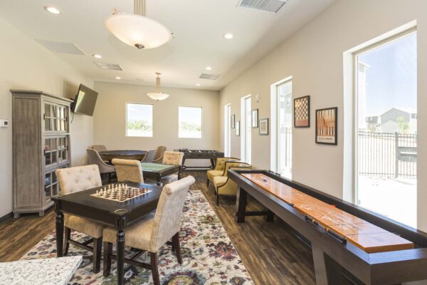 The Retreat at Patriot Park game room with shuffleboard, foosball, and chess.