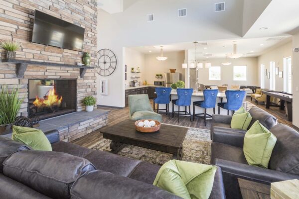 The Retreat at Patriot Park clubhouse with plush seating, community kitchen, and fireplace.