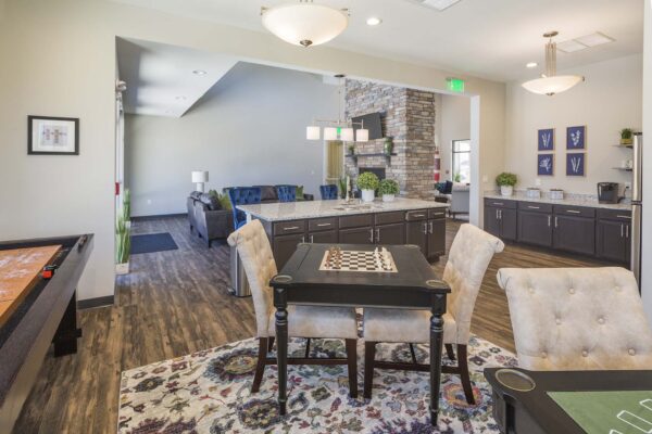 The Retreat at Patriot Park clubhouse with community kitchen, game room, and seating area.