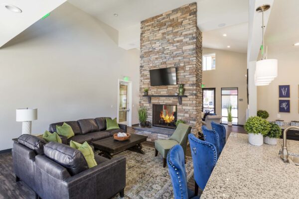 The Retreat at Patriot Park clubhouse with plush seating, fireplace, and TV.