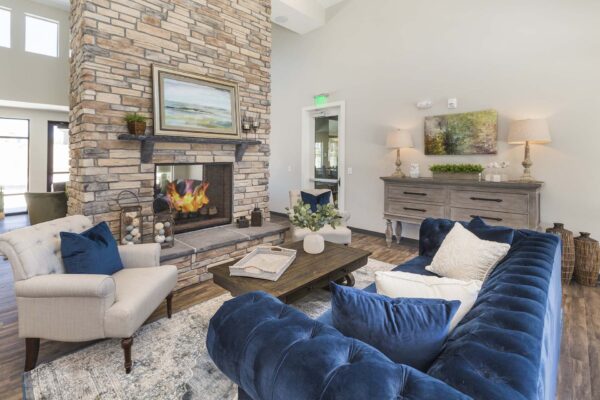 The Retreat at Patriot Park clubhouse with plush seating, fireplace, and elegant decor.