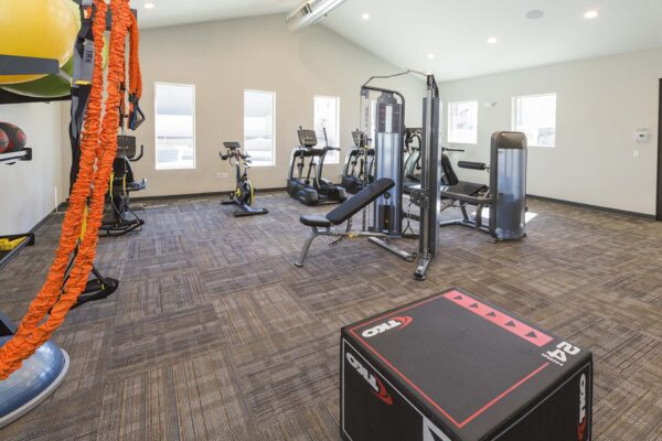 The Retreat at Patriot Park fitness center with cardio machines and weight equipment.