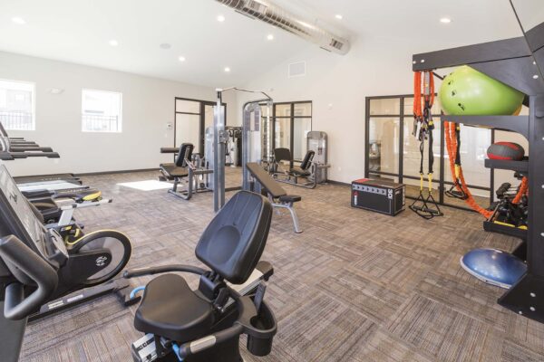 The Retreat at Patriot Park fitness center with cardio machines and weight equipment.