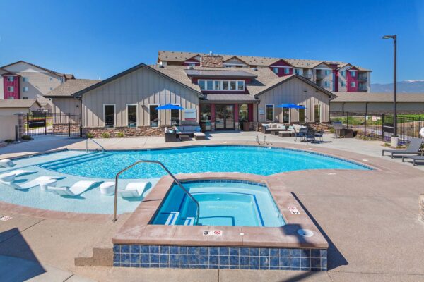 The Retreat at Patriot Park pool area with outdoor seating and hot tub.