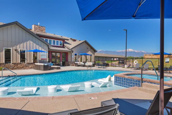 The Retreat at Patriot Park pool area with outdoor seating and hot tub.